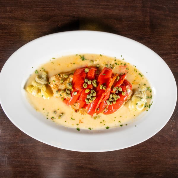 Chicken piccata with roasted red peppers, artichoke hearts, capers, and a creamy sauce.