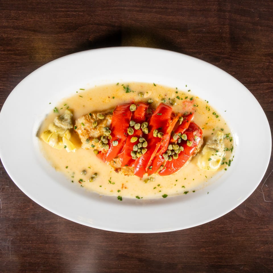 Chicken piccata with roasted red peppers, artichoke hearts, capers, and a creamy sauce.